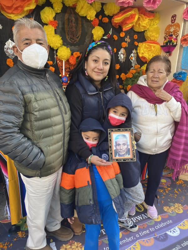 Erika Espinosa, co-owner and co-founder of Colores Mexicanos with her family in front of a special ofrenda they set up on Chicago's Riverwalk in 2021. <p>Courtesy of Erika Espinosa</p>
