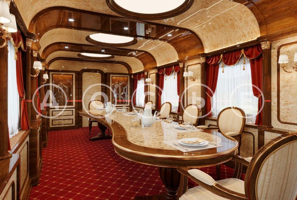 The dining car can be seen furnished with plush red carpet, curtains and a long, art deco-style table (Dossier Center)