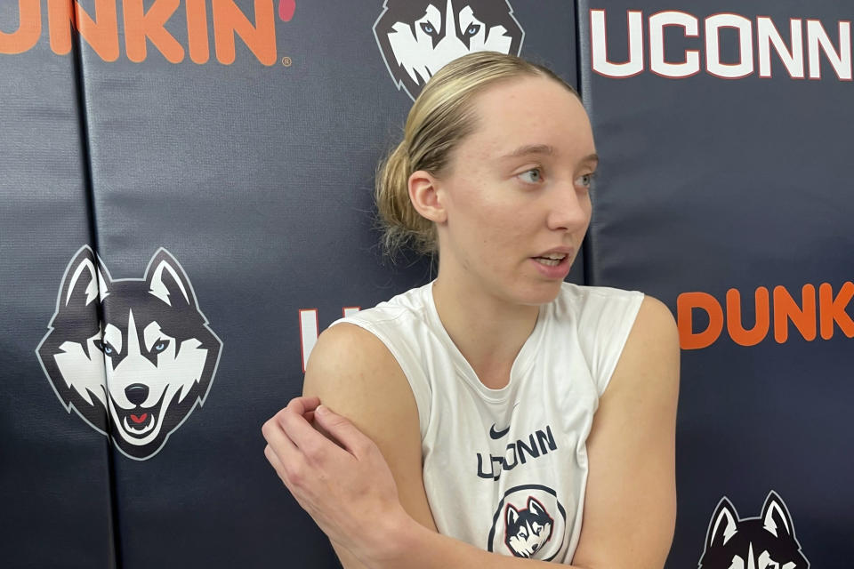 Connecticut guard Paige Bueckers speaks to reporters following a team workout with the NCAA college basketball team, Wednesday, june 14, 2023, in Storrs, Conn. UConn's star is back on the court, though not fully participating in practice games yet, 10 months after suffering the second major knee injury of her college career. (AP Photo/Pat Eaton-Robb)