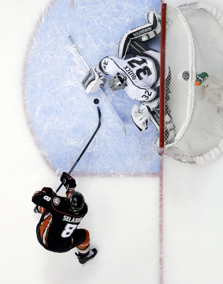 Los Angeles Kings goalie Jonathan Quick, top, blocks a shot by Anaheim Ducks right wing Teemu Selanne during the first period in Game 5 of an NHL hockey second-round Stanley Cup playoff series in Anaheim, Calif., Monday, May 12, 2014. (AP Photo/Chris Carlson)