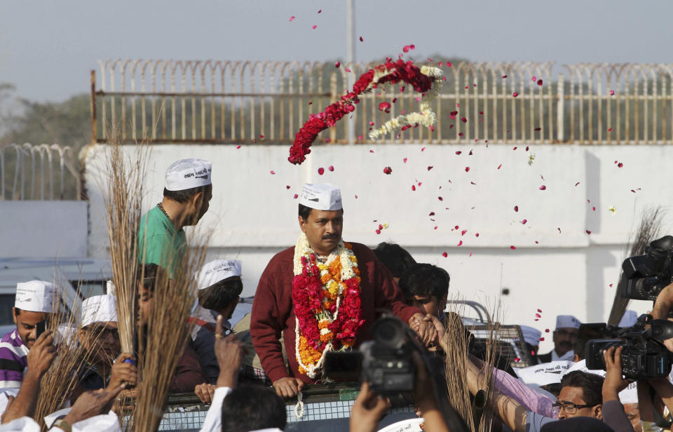 A supporter throws a floral garland at anti-graft activist and leader of Aam Aadmi Party, or Common Man Party, Arvind Kejriwal upon his arrival for a four-day visit of Gujarat state ahead of the country’s national elections, in Ahmadabad, India, Wednesday, March 5, 2014. India said Wednesday it will begin national elections on April 7, kicking off a month-long contest in the largest democracy in the world. More than 810 million people are eligible to vote this year, an increase of 100 million from five years ago, according to the Election Commission. (AP Photo/Ajit Solanki)