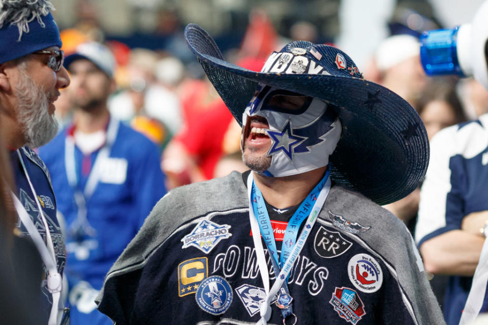 Why is this fan smiling? Because he’s one of the NFL’s best. (Getty)