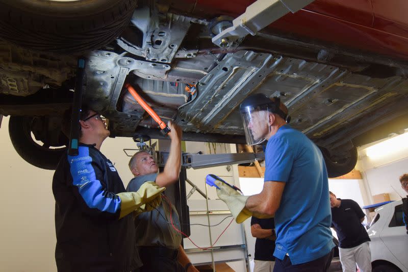 An instructor at automotive training provider Pro-Moto during an electric vehicle repair course in Ash Vale