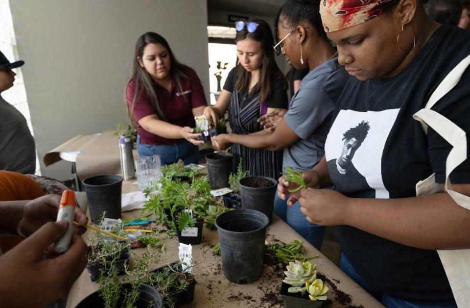 Vickie Crockett, 20, right, and other young people create plant arrangements during the Youth Climate Justice Summit at the Redeemer Church in Modesto, Calif., Friday, July 28, 2023.