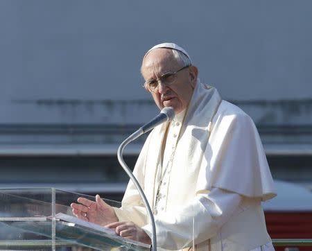 Pope Francis addresses the faithful outside the 'White Houses' in the Forlanini district of Milan, Italy, March 25, 2017. REUTERS/Alessandro Garofalo