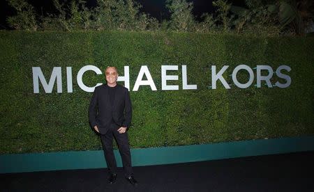 Fashion designer Michael Kors poses at a launch dinner for Claiborne Swanson Frank's photo book "Young Hollywood" with a foreword by Kors in Beverly Hills, California in this file photo from October 2, 2014. REUTERS/Mario Anzuoni/Files