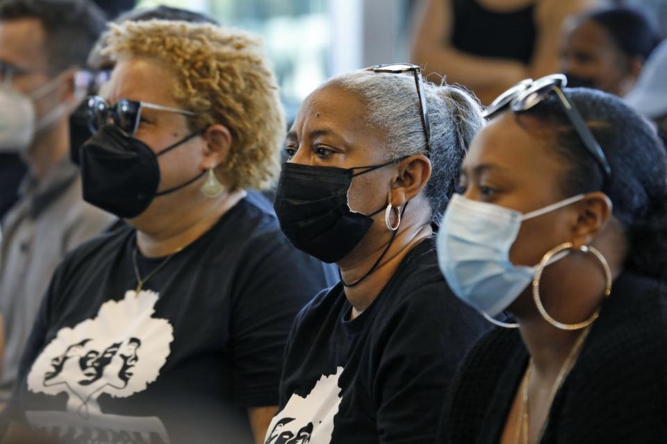 Michel Dory, left, Yolanda Floyd, center, and Destiny Floyd, right, listen to Rep. Karen Bass.