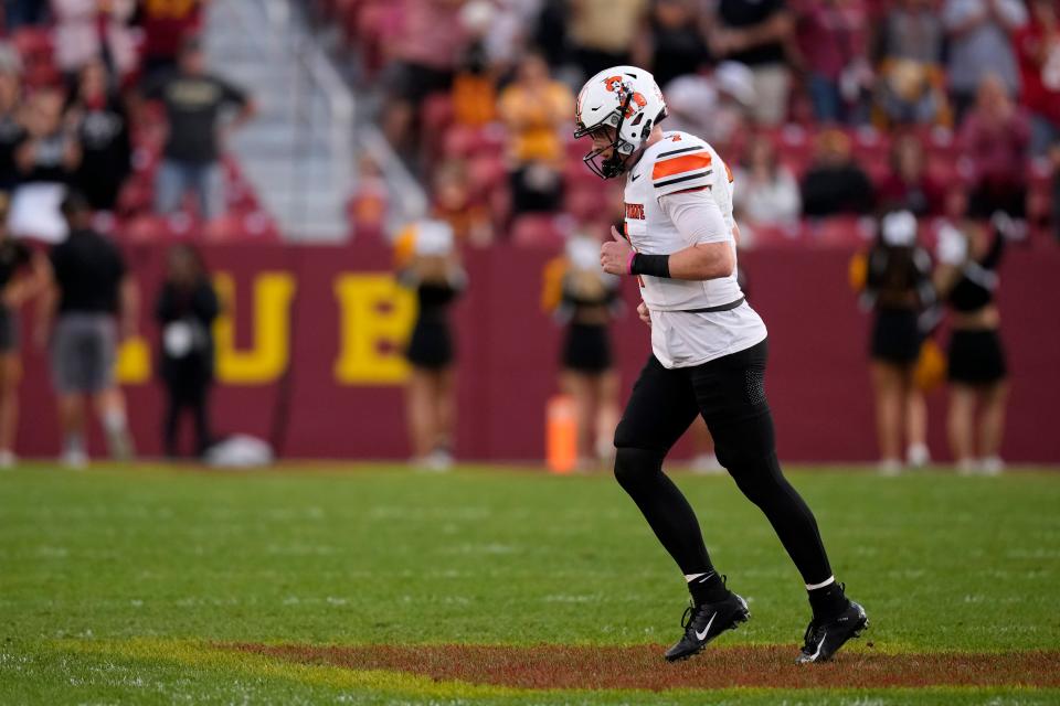 Oklahoma State quarterback Alan Bowman runs off the field after throwing an interception during the second half of an NCAA college football game against Iowa State, Saturday, Sept. 23, 2023, in Ames, Iowa. Iowa State won 34-27. (AP Photo/Charlie Neibergall)