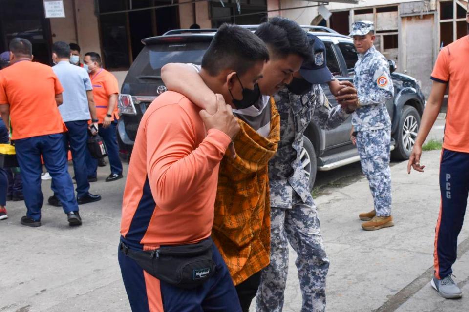 In this handout photo provided by the Philippine Ports Authority Zamboanga, rescuers assist a survivor of the MV Lady Mary Joy fire as some of the survivors arrive in Zamboanga, southern Philippines Thursday Mar. 30, 2023.