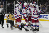 New York Rangers left wing Alexis Lafrenière (13) celebrates with teammates after scoring against the Vegas Golden Knights during the third period of an NHL hockey game Wednesday, Dec. 7, 2022, in Las Vegas. (AP Photo/John Locher)