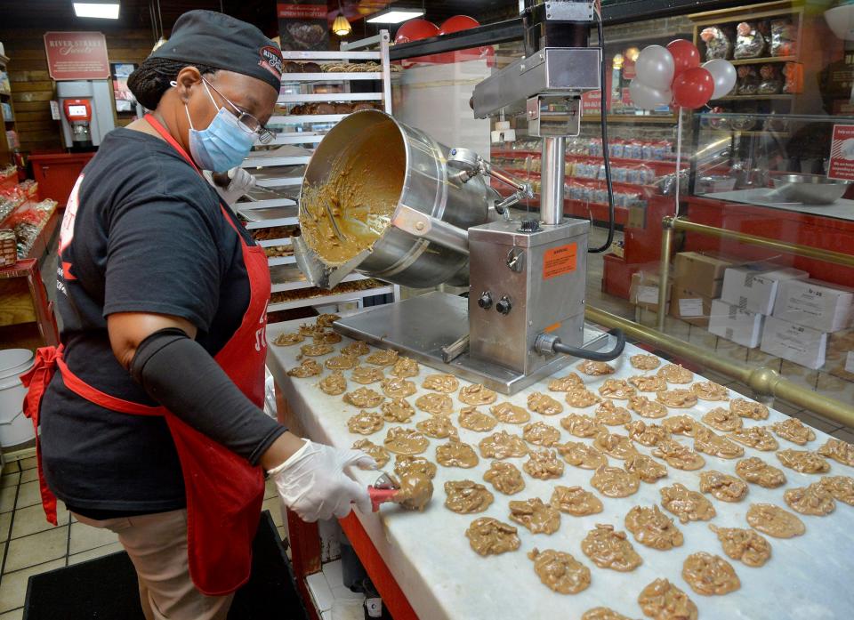 FILE - Rene Platts prepares pralines at River Street Sweets on River Street. Yelp ranks it as one of the best spots in the area to enjoy pralines.