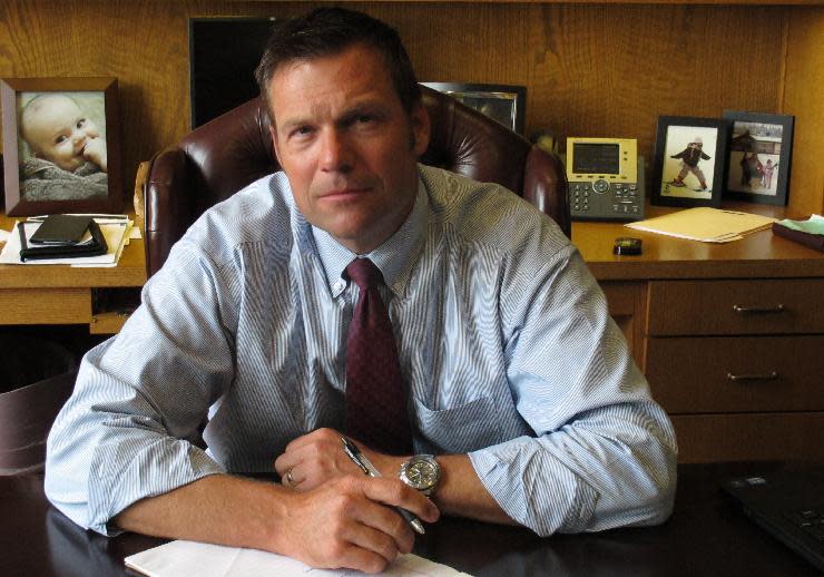 FILE - In this Aug. 1, 2013, file photo, Kansas Secretary of State Kris Kobach, the architect of the state's proof-of-citizenship law for new voters, answers questions during an Associated Press interview in Topeka, Kan. U.S. District Judge Eric Melgren in Wichita, Kan., ruled on Wednesday, March 19, 2014, that the U.S. Election Assistance Commission has no legal authority to deny requests from Kansas and Arizona to add state-specific instructions to a national voter registration form. The states and their top election officials — secretaries of state Kris Kobach of Kansas and Ken Bennett of Arizona — sued the agency to force the action. (AP Photo/John Hanna, File)