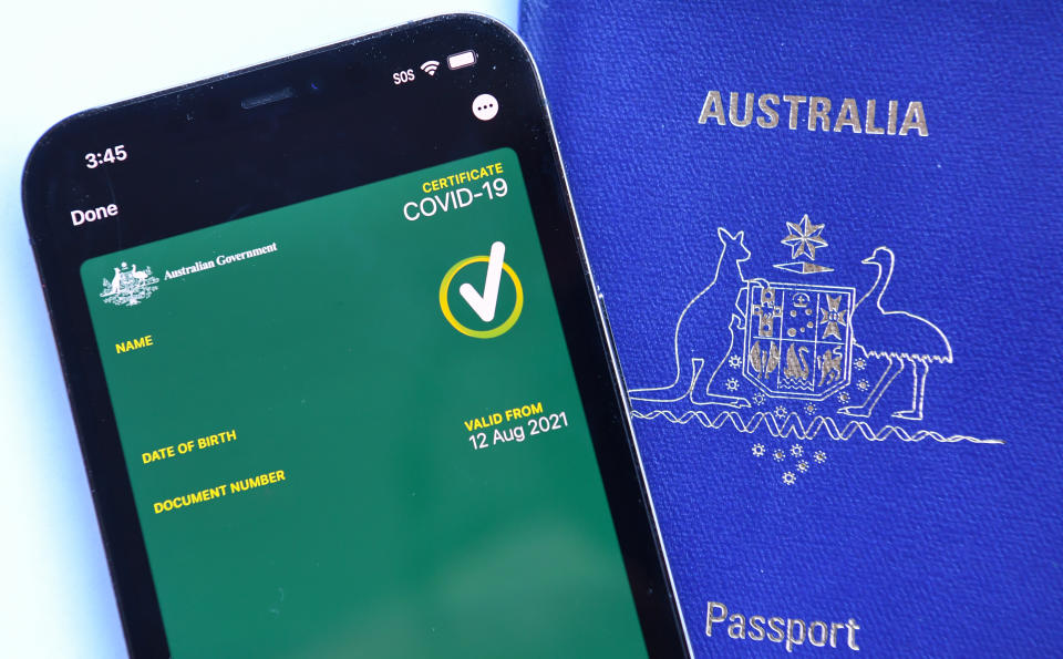 A mobile phone with an Australian Covid-19 certificate on it next to an Australian passport on August 15, 2021 in Sydney, Australia. Potential travel in Australia may require the digital vaccine confirmation in the future.