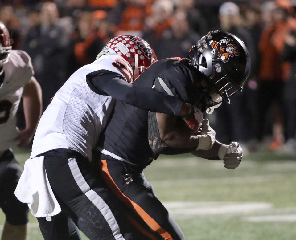 Massillon's Ja'Meir Gamble, right, pulls Westerville South defender Cameron Garcia across the goal line for a score during a playoff game, Nov. 3, 2023.