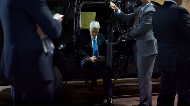 PHOTO: A photo taken by a White House photographer on Jan. 6, 2021 shows Vice President Mike Pence looking at a tweet by President Donald Trump on his phone in an underground parking garage of the U.S. Capitol complex during the insurrection. (Fishel, Justin/White House )