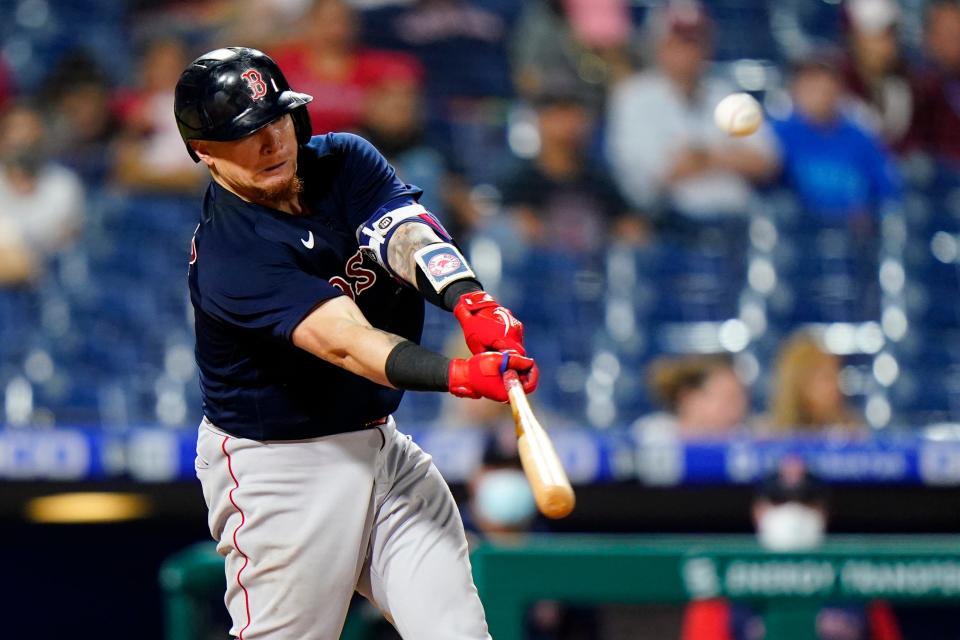 Christian Vazquez hits a three-run double off Phillies pitcher Chase Anderson during an interleague game in May 2021 in Philadelphia.