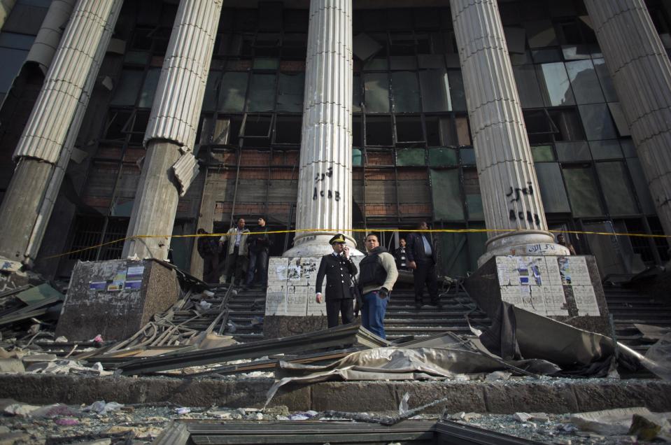 Egyptian police check the damage after an explosion at the Imbaba courthouse amid a massive security operation to protect polling stations, in Cairo, Egypt, Tuesday, Jan. 14, 2014. Egyptians have started voting on a draft for their country's new constitution that represents a key milestone in a military-backed roadmap put in place after President Mohammed Morsi was overthrown in a popularly backed coup last July. (AP Photo/Khalil Hamra)