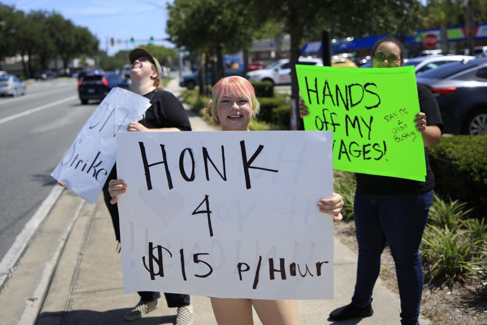 Alicia Permenter, center, stands on the picket line Monday with Mason Boykin, left, and Kristen DuBose at the Ricky Drive Starbucks at 11441 San Jose Blvd. in Jacksonville. The partners were demanding they receive the $15 an hour minimum pay raise that non-unionized stores received at the beginning of the month.