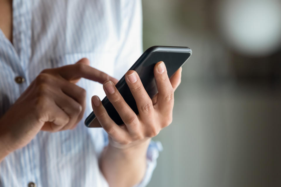 Close-up of a person using a smartphone with both hands