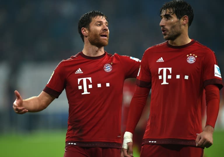 Bayern Munich's Xabi Alonso (L) and Javier Martinez celebrate after their German first division Bundesliga match against Schalke, in Gelsenkirchen, on November 21, 2015