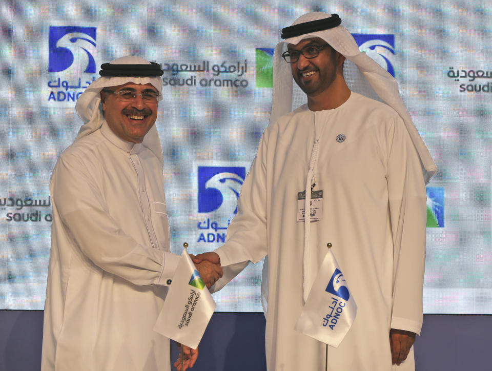 Saudi Aramco President Amin al-Nasser, left, shakes hands with Sultan Ahmed Al Jaber, UAE Minister of State and ADNOC Group CEO after they signed a contract in the opening day of the Abu Dhabi International Exhibition & Conference, ADIPEC, in Abu Dhabi, United Arab Emirates, Monday, Nov. 12, 2018. OPEC and allied oil-producing countries likely need to cut crude supplies to rebalance the market after proposed U.S. sanctions on Iran failed to cut Tehran's ouput, top Saudi and Emirati energy officials said Monday. (AP Photo/Kamran Jebreili)