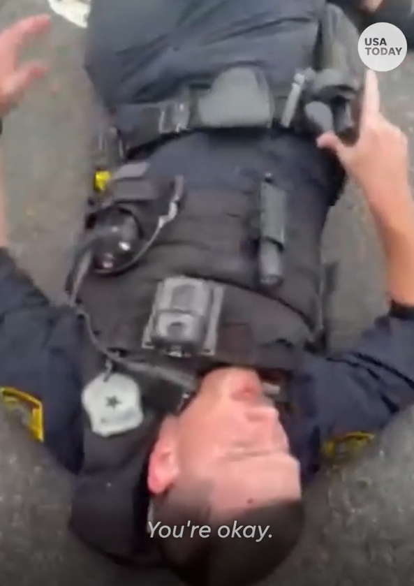 Houston police Officer John Gibson is pictured shortly after being dragged to safety by a citizen named John Lally following a shootout with a carjacking suspect on Nov. 11, 2023.