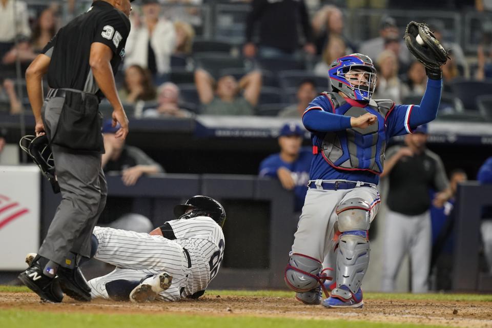 Texas Rangers catcher Jose Trevino tags out New York Yankees' Kyle Higashioka at home plate during the fifth inning of a baseball game Wednesday, Sept. 22, 2021, in New York. (AP Photo/Frank Franklin II)