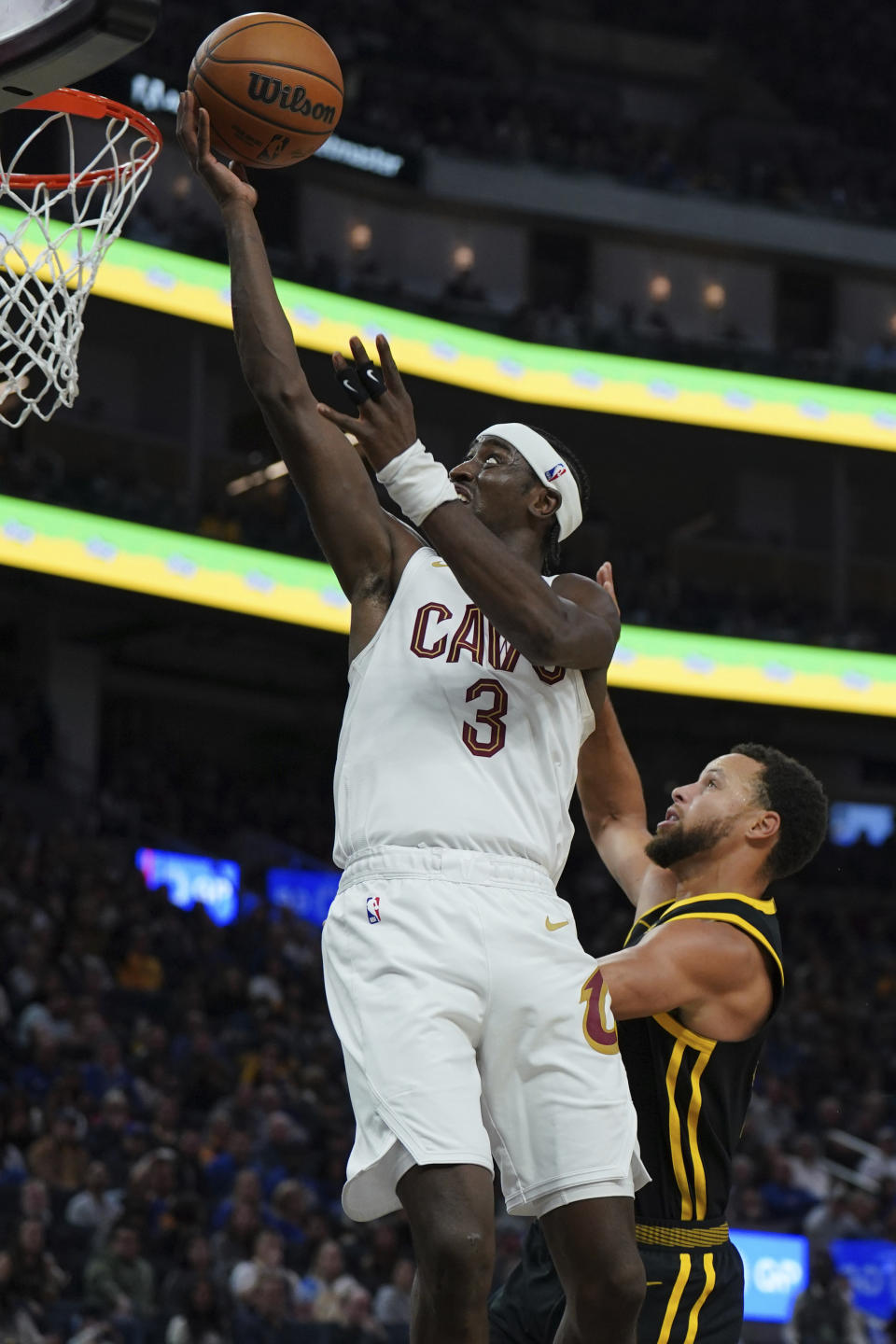 Cleveland Cavaliers guard Caris LeVert (3) drives to the basket as Golden State Warriors guard Stephen Curry (30) defends during the first half of an NBA basketball game Saturday, Nov. 11, 2023, in San Francisco. (AP Photo/Loren Elliott)