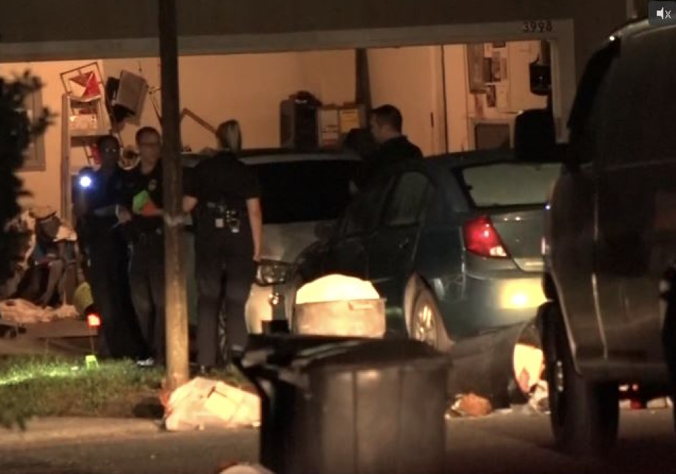 Jacksonville police investigate a burglary crime scene off Old Middleburg Road where an officer and suspect traded gunfire late Sunday. One officer was hit in the back but was wearing a bulletproof vest. The apparent suspect fled, crashed during the pursuit on the Dames Point bridge and died after jumping into the St. Johns River, police said.