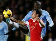 Manchester City's Yaya Toure challenges Southampton's Jack Cork (front) during their English Premier League soccer match at St Mary's stadium in Southampton, southern England December 7, 2013. REUTERS/Stefan Wermuth