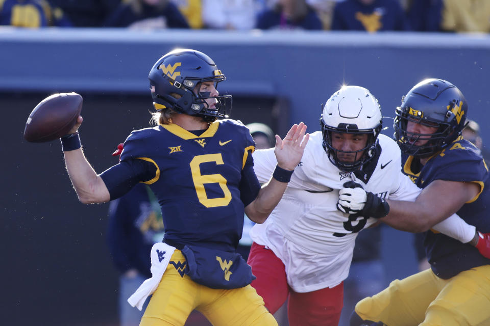 West Virginia quarterback Garrett Greene passes during the first half of an NCAA college football game against Cincinnati, Saturday, Nov. 18, 2023, in Morgantown, W.Va. (AP Photo/Chris Jackson)