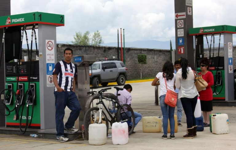 People buy gas cans at a station in Oaxaca, Mexico, on June 5