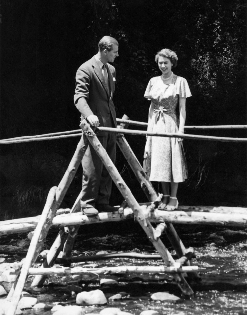 <p>Princess Elizabeth and the Duke of Edinburgh on a bridge in the grounds of Sagana Lodge, Kenya, on 5 February 1952. The following day, her father King George VI died and Elizabeth became Queen. (Getty Images)</p> 