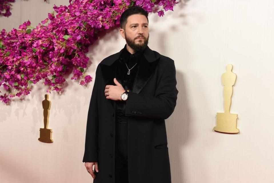 John Magaro arrives for the 96th Academy Awards.