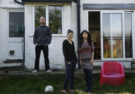 Romanian migrants Marius Spiridon and sisters Mihaela and Andreea Toniciuc (R) pose in the garden of the house where Marius lodges, after an interview with Reuters in Hendon, north London March 15, 2014. REUTERS/Luke MacGregor