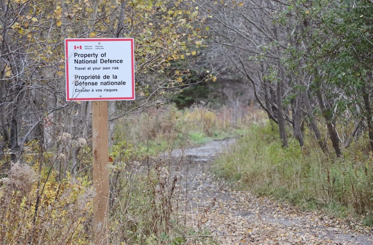 In October, signs went up saying the road belongs to National Defence and online property records seem to confirm that, but Fisheries and Oceans now says it's their road. (Tom Ayers/CBC - image credit)