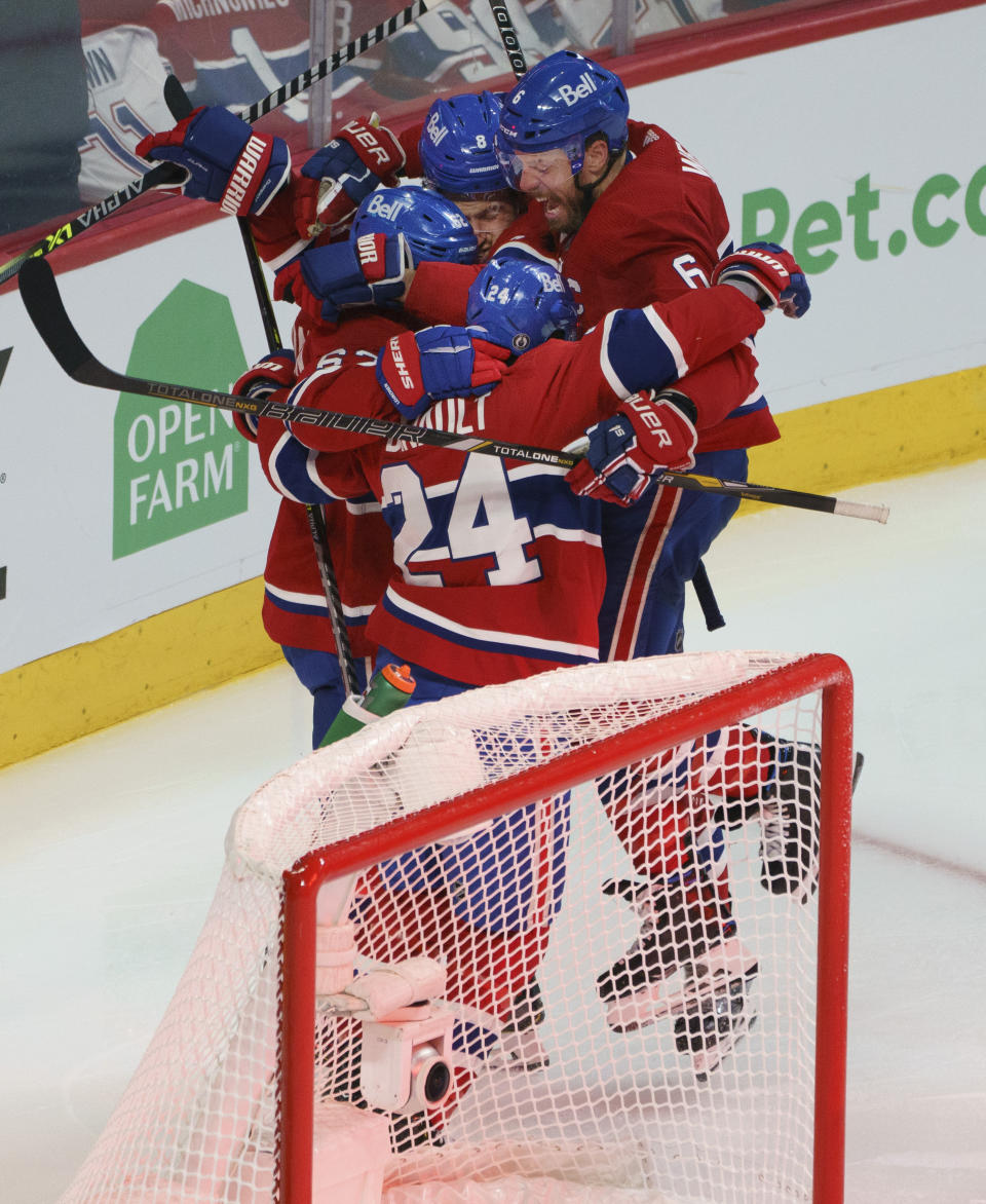 Montreal Canadiens' Shea Weber (6) leaps onto teammates as they mob teammate Artturi Lehkonen, obscured, to celebrate his game-winning goal during overtime in Game 6 of an NHL hockey Stanley Cup semifinal playoff series against the Montreal Canadiens Thursday, June 24, 2021 in Montreal. (Paul Chiasson/The Canadian Press via AP)