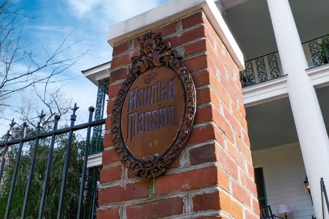 <p>George Stewart Impact Photo</p> The Haunted Mansion plaque at the entryway