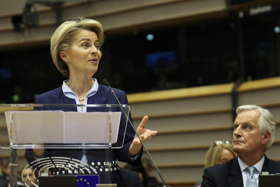 European Commission President Ursula von der Leyen, left, addresses European lawmakers next to European Union chief Brexit negotiator Michel Barnier during the plenary session at the European Parliament in Brussels, Wednesday, Jan. 29, 2020. The U.K. is due to leave the EU on Friday, Jan. 31, 2020, the first nation in the bloc to do so. (AP Photo/Francisco Seco)