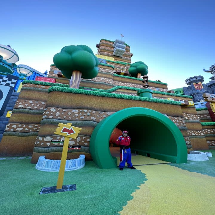 The Warp Tunnel with a pathway that leads inside and a guard standing at the entryway