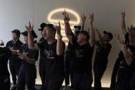 Workers practice their cheer before the opening of the first Beijing outlet for Shake Shack in Beijing Wednesday, Aug. 12, 2020. The U.S. headquartered burger chain is opening its first Beijing restaurant at a time when China and the US are at loggerheads over a long list of issues. (AP Photo/Ng Han Guan)