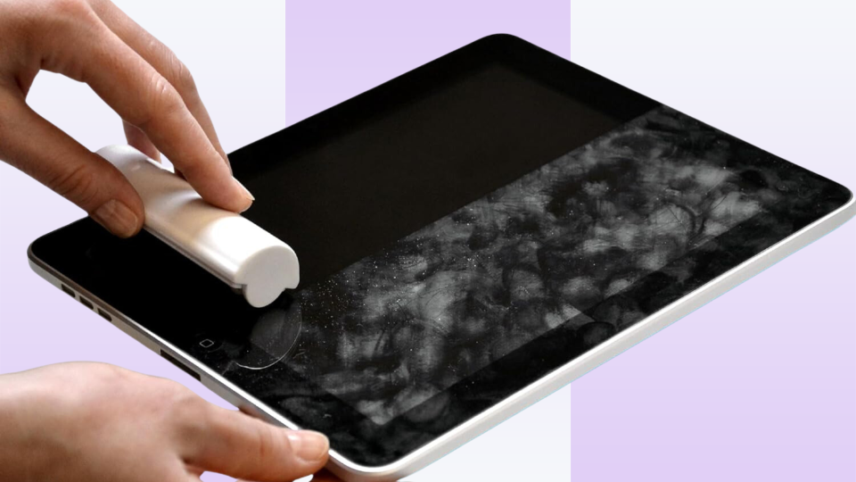 person using the iRoller to clean an iPad screen