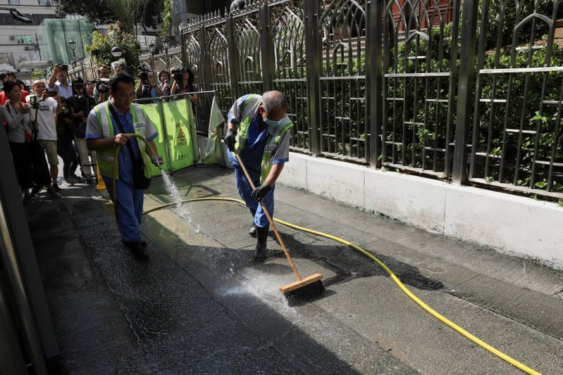 Cleaners wash the walkway outside Kowloon Masjid and Islamic Centre in Hong Kong’s tourism district Tsim Sha Tsui