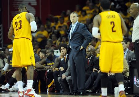 Cleveland Cavaliers head coach David Blatt talks with forward LeBron James (23) and guard Kyrie Irving (2) during the third quarter against the Atlanta Hawks in game four of the Eastern Conference Finals of the NBA Playoffs at Quicken Loans Arena. Mandatory Credit: Ken Blaze-USA TODAY Sports