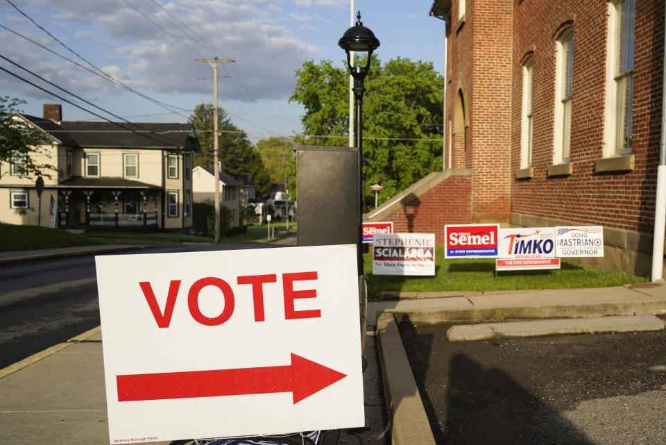 Signs point the way for voters to cast their ballots at the polling location for the Pennsylvania primary election, Tuesday, May 17, 2022, in Harmony, Pa., (AP Photo/Keith Srakocic)