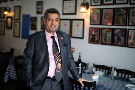 Iranian expatriate Roozbeh Farahanipour poses for a photo in his restaurant in Los Angeles, California U.S. January 3, 2018. REUTERS/Lucy Nicholson