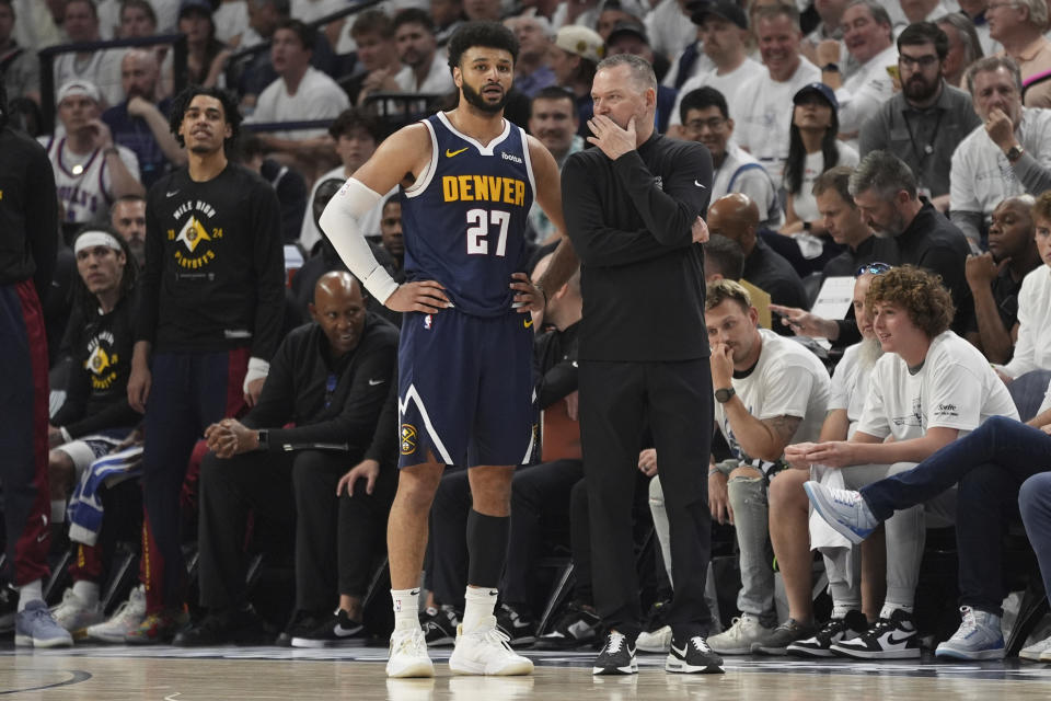Denver Nuggets guard Jamal Murray (27) and head coach Michael Malone stand on the court during the first half of Game 4 of an NBA basketball second-round playoff series against the Minnesota Timberwolves, Sunday, May 12, 2024, in Minneapolis. (AP Photo/Abbie Parr)