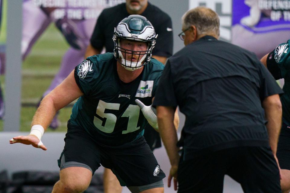 Philadelphia Eagles' Cam Jurgens, left, in action against offensive lines coach Jeff Stoutland, right, during at NFL rookie football minicamp, Friday, May 6, 2022, in Philadelphia. (AP Photo/Christopher Szagola)