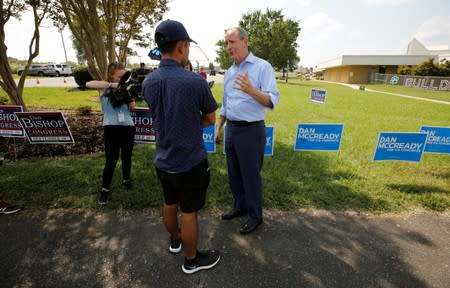 Dan Bishop, Republican candidate in the special election for North Carolina's 9th Congressional District, speaks to the media near campaign signs for him and for his Democratic opponent Dan McCready, outside a polling station in Indian Trail, North Carolin