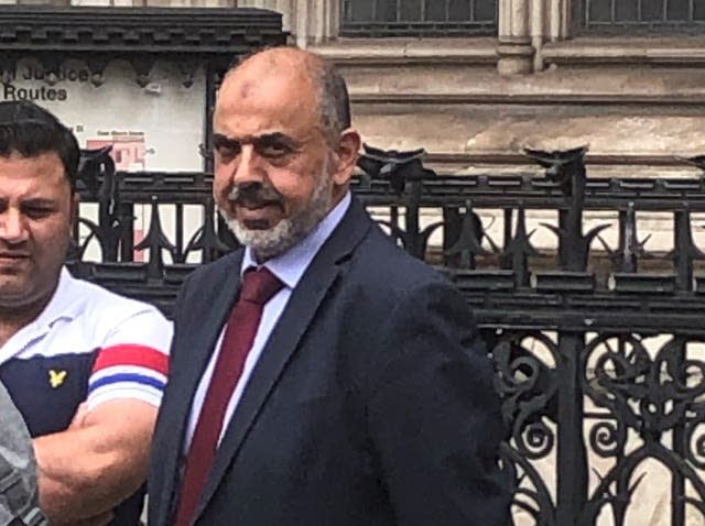 Ahmed, centre, outside the Royal Courts of Justice in London on Tuesday